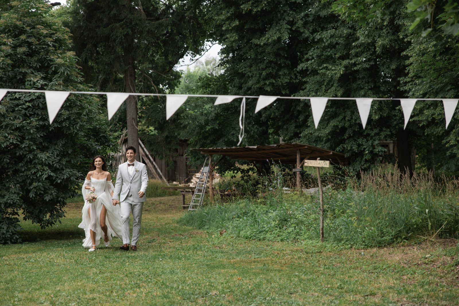 Couple walking hand in hand through the manor grounds
